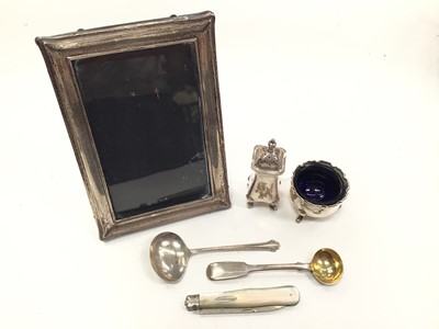 Lot 1081 - Silver salt and pepperette, two silver spoons, silver and mother of pearl fruit knife and a silver photograph frame