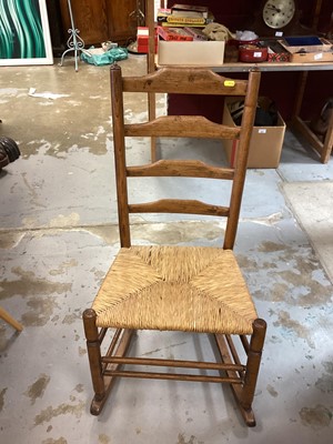 Lot 1384 - Oak ladderback rocking chair with rush seat