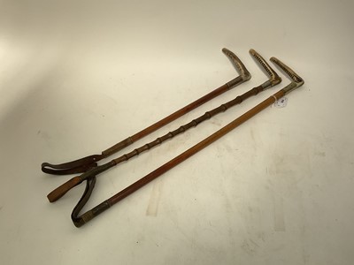 Lot 1139 - Three antique hunting whips with white metal collars and bamboo shafts with antler handles