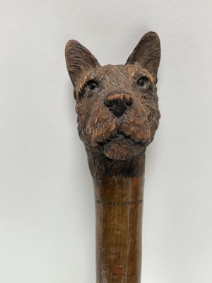 Lot 934 - Swaine & Adeney stick with a carved terrier head knop, stamped to shaft, 94cm long, together with another antique cane, the white metal top inset with an enamel panel depicting a fox (2)