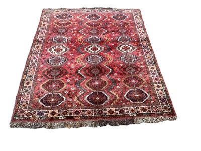 Lot 1431 - Eastern rug with 27 medallions on red ground, 158cm x 127cm