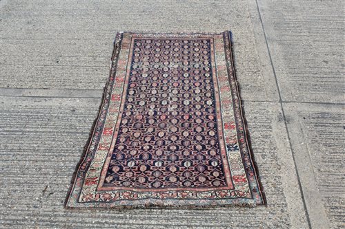 Lot 1550 - Persian rug, the navy field with allover...