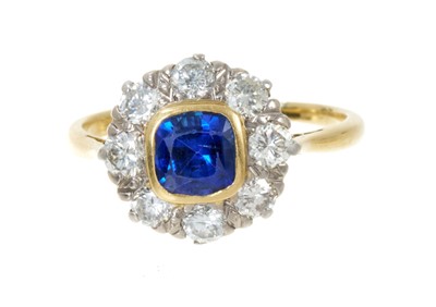 Lot 494 - Sapphire and diamond cluster ring with a cushion shape mixed cut blue sapphire measuring approximately 6 x 5 x 3.9mm surrounded by a border of eight brilliant cut diamonds estimated to weigh app...