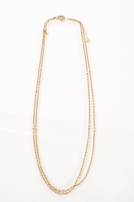 Lot 499 - Edwardian gold two-strand necklace with gold chain links and pearl spacers on a pearl and diamond clasp, 52cm.