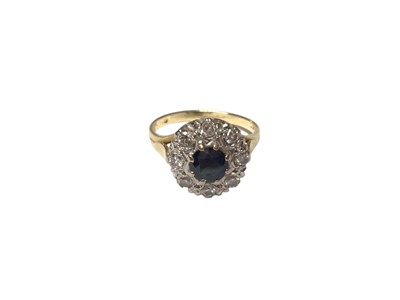 Lot 101 - Sapphire and diamond cluster ring In 18ct gold setting