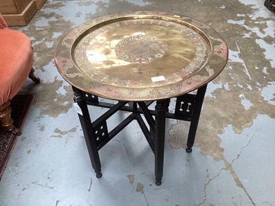 Lot 1438 - Eastern folding occasional table with folding brass top. 57cm diameter.