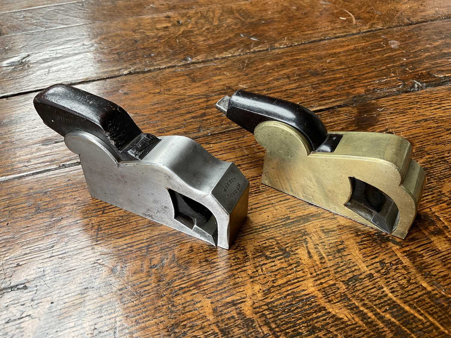 Lot 2419 - Two small bull nose planes, the largest in steel and ebony, by Norris, 13cm long, another similar in gunmetal, apparently unsigned. (2)