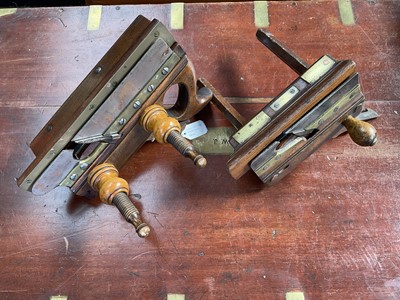 Lot 2423 - 19th century beech boxwood screw plough by Sorby with brass mounts, 30cm long, and another, with collectors label attributing it to Griffiths of Norwich. (2)