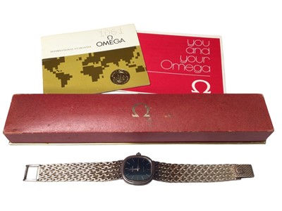Lot 52 - Omega De Ville ladies silver wristwatch with a navy dial and silver baton markers, on a woven silver strap (London import mark, 1975), in original box with booklets