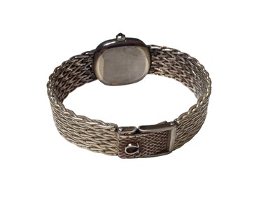 Lot 52 - Omega De Ville ladies silver wristwatch with a navy dial and silver baton markers, on a woven silver strap (London import mark, 1975), in original box with booklets