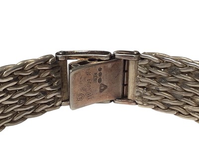 Lot 52 - Omega De Ville ladies silver wristwatch with a navy dial and silver baton markers, on a woven silver strap (London import mark, 1975), in original box with booklets