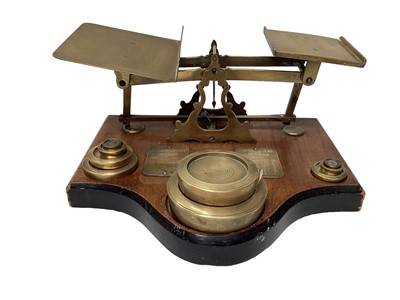 Lot 2596 - Set of antique brass parcel scales on a wooden base, 36cm wide