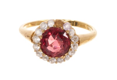 Lot 452 - Antique spinel and white sapphire cluster ring with a round mixed cut red spinel measuring 7.5mm diameter, surrounded by a border of synthetic white sapphires, in claw setting on 18ct gold shank...