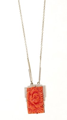 Lot 466 - Art Deco carved coral pendant necklace in white metal setting, stamped 9ct.