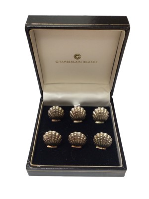 Lot 66 - Cased set of six Chamberlain Clarke sterling silver scallop shell menu holders (Sheffield 1996)