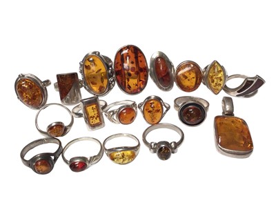 Lot 118 - Collection of seventeen silver and amber dress rings and a pendant (18)