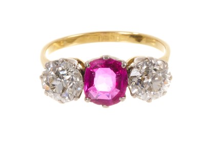 Lot 450 - Fine ruby and diamond three stone ring with an oval mixed cut ruby flanked by two old cut diamonds in platinum claw setting on 18ct gold shank