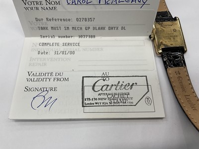 Lot 589 - Ladies Cartier Must de Cartier tank wristwatch with mechanical movement, black 'onyx' dial in silver gilt tank shaped case on leather strap. Service receipt from Cartier
