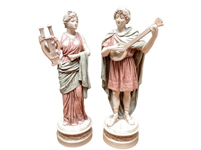 Lot 1143 - Pair of Royal Dux figures playing musical instruments, pink triangle mark to base, numbered 143 and 144, 31.5cm high and 30.5cm high