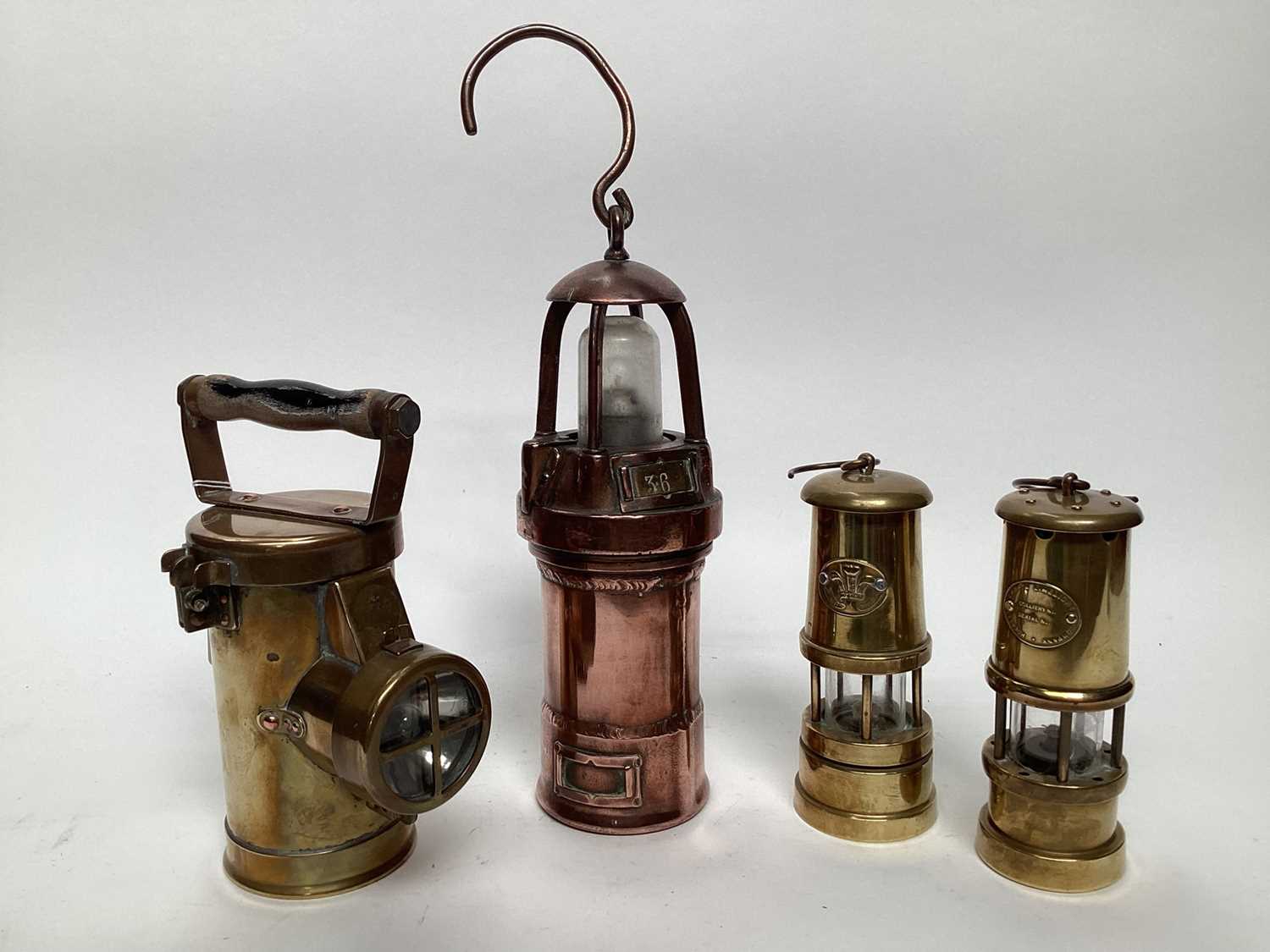 Lot 2626 - The CEAG inspection lamp, a French battery powered copper miners' lamp, a musical miners' lamp and a small Lamp & Limelight lamp (4)