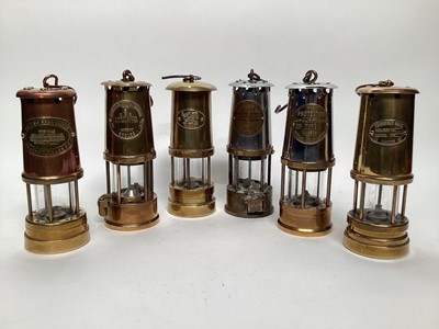 Lot 2628 - Group of brass, copper and steel miner's lamps, including three Protector lamps, one Ferndale Coal, one British Coal Mining, and one stamped Cymru (6)