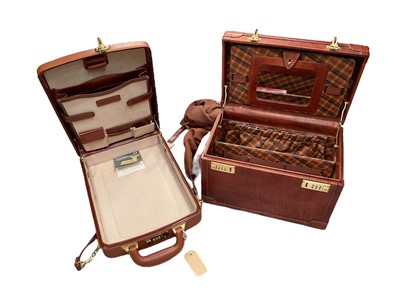 Lot 718 - Two leather cases with combination locks