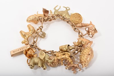 Lot 559 - 9ct gold charm bracelet with a collection of 9ct gold and yellow metal charms, and three loose charms