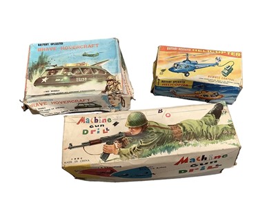 Lot 1943 - Battery operated toys including machine gun drill, brave hovercraft, helicopter by Marx & Co, Tomy talking combat tank, all boxed (boxes mixed condition) (4)