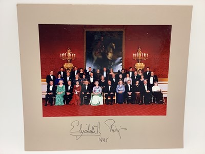 Lot 3 - H.M. Queen Elizabeth II and H.R.H. The Duke of Edinburgh, signed presentation colour photograph of the Royal couple with guests following a Royal dinner including Air Vice Marshal Sir John Severn...