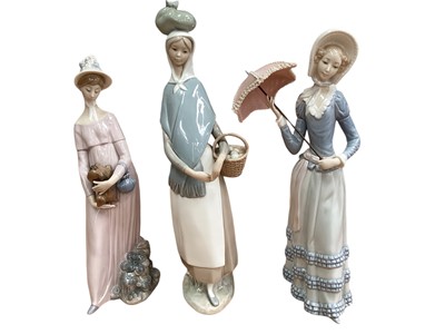 Lot 1228 - Five Lladro porcelain figures including lady with parasol and lady with basket of fruit