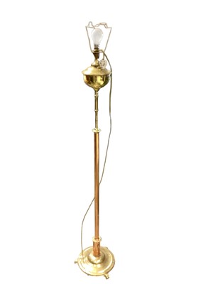 Lot 1344 - Victorian-style brass standard lamp in the form of an oil lamp, together with another modern standard lamp