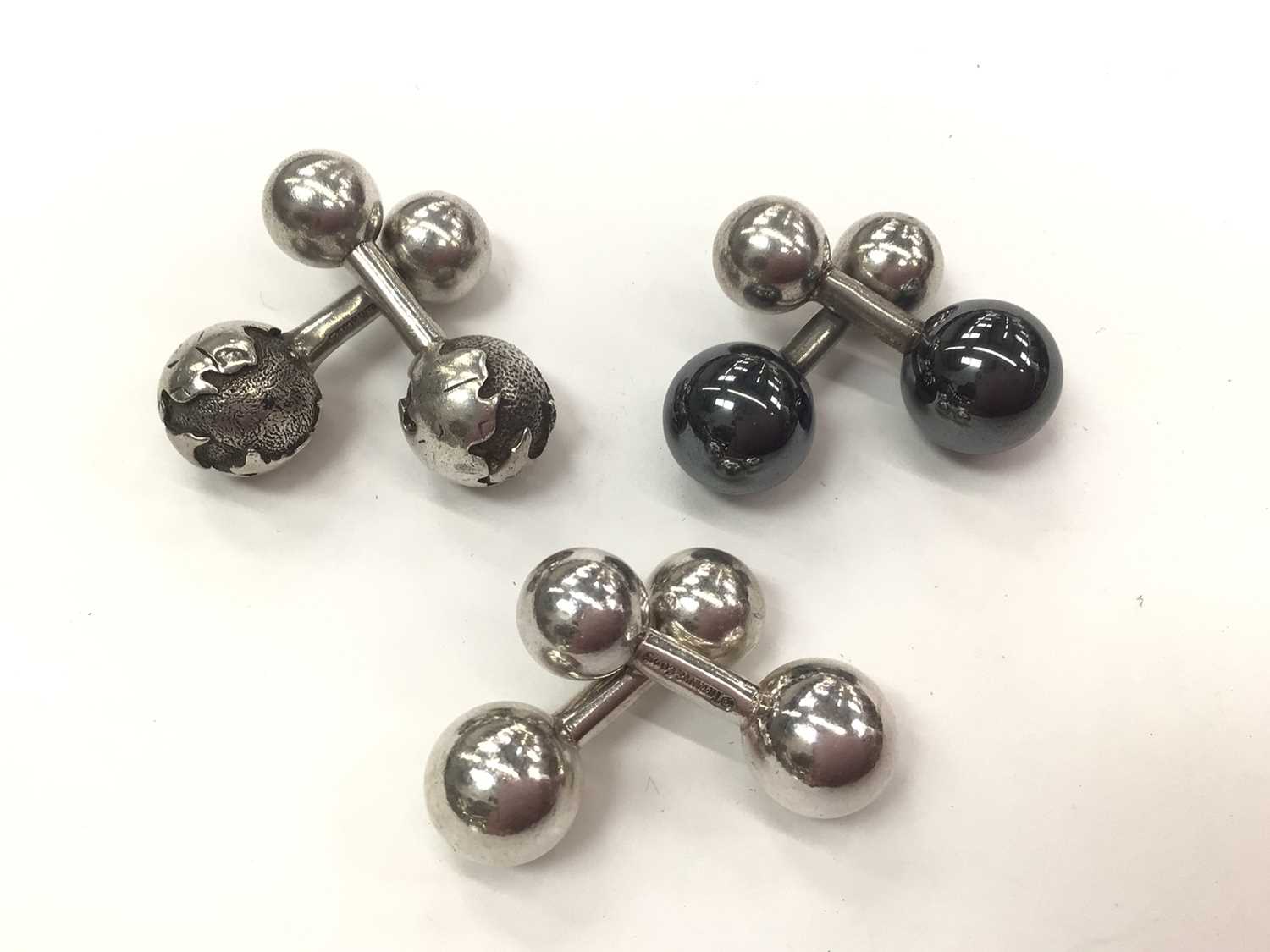 Lot 195 - Three pairs of Tiffany & Co silver ball end cufflinks to include one globe pair, one hematite pair and one other pair