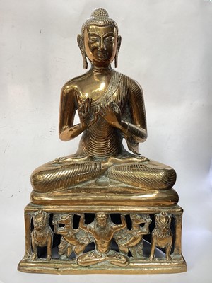 Lot 2533 - Indian brass Buddha with reticulated base and Indian brass dinner gong on stand (2)