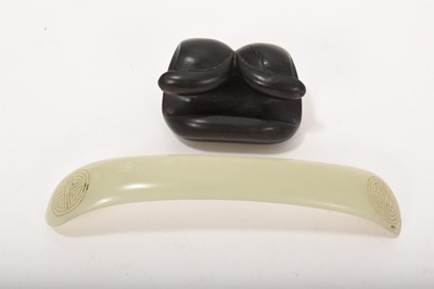 Lot 794 - Antique Chinese celadon jade carving, possibly a hairpin, on a wooden stand