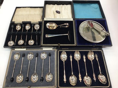 Lot 212 - Two sets of six silver bean end coffee spoons, set of six silver Apostle teaspoons, silver spoon and pusher set and a plated dentist's mirror, all in fitted cases (5)