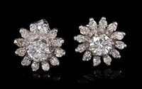 Lot 671 - Pair diamond earrings, each flower-head...