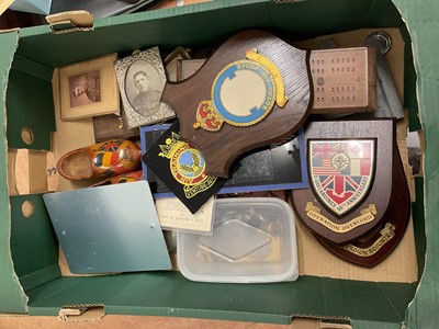 Lot 737 - Group of assorted Militaria to include cap badges, brass tankard made from shells from the battlefields of North Africa, regimental crests and other items (1 box).