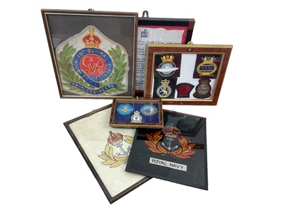 Lot 738 - Collection of cloth military badges in glazed frames, embroidered regimental badges and other militaria (1 box).