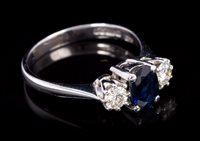 Lot 676 - Sapphire and diamond three stone ring with an...