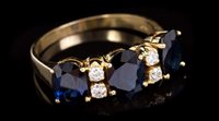 Lot 679 - Sapphire and diamond ring with three oval...