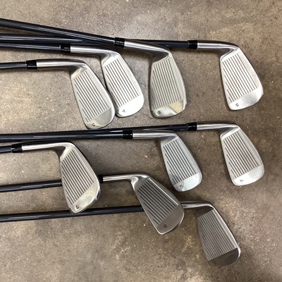 Lot 2573 - An unused set of carbon fibre shafted golf irons plus a tray and a bag of miscellaneous golf items including gents and ladies golf shoes