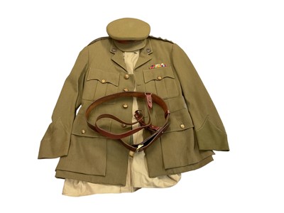 Lot 754 - Second World War era Bedfordshire and Hertfordshire Regiment Captain's uniform with mounted medal ribbons, badges and rank insignia, together with Sam Browne belt and hat.