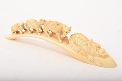 Lot 755 - Antique Japanese boar's tusk carved with three goats behind a dragon