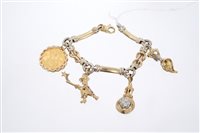 Lot 685 - Gold (9ct) charm bracelet with three figural...