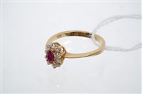 Lot 692 - Ruby and diamond cluster ring, the oval mixed...