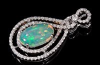 Lot 695 - Opal and diamond pendant, the oval cabochon...