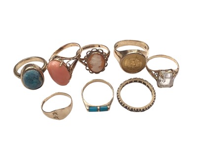 Lot 231 - Five 9ct gold rings including a cameo and coin ring, yellow metal pink coral ring, yellow metal eternity ring and a turquoise ring (8)