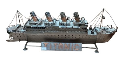 Lot 2687 - German metal model of the RMS Titanic together with a framed Titanic poster (2).