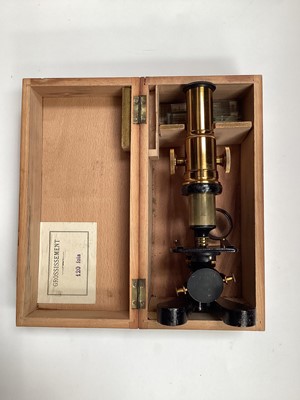 Lot 2523 - Antique French lacquered brass microscope in case with a few slides