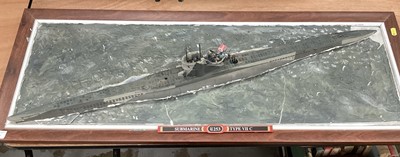 Lot 2657 - Three models of ships on naturalistic plaster bases, including two U-Boats and an aircraft carrier, the largest 96cm long Together with another aircraft carrier